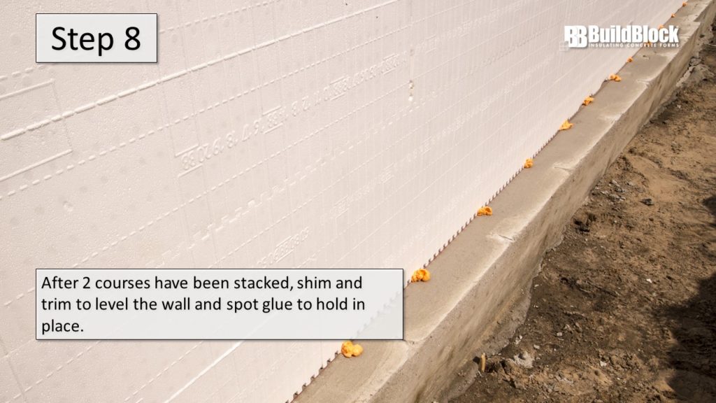Step 8: After two courses have been stacked, shim and trim to level the wall and spot glue to hold in place.