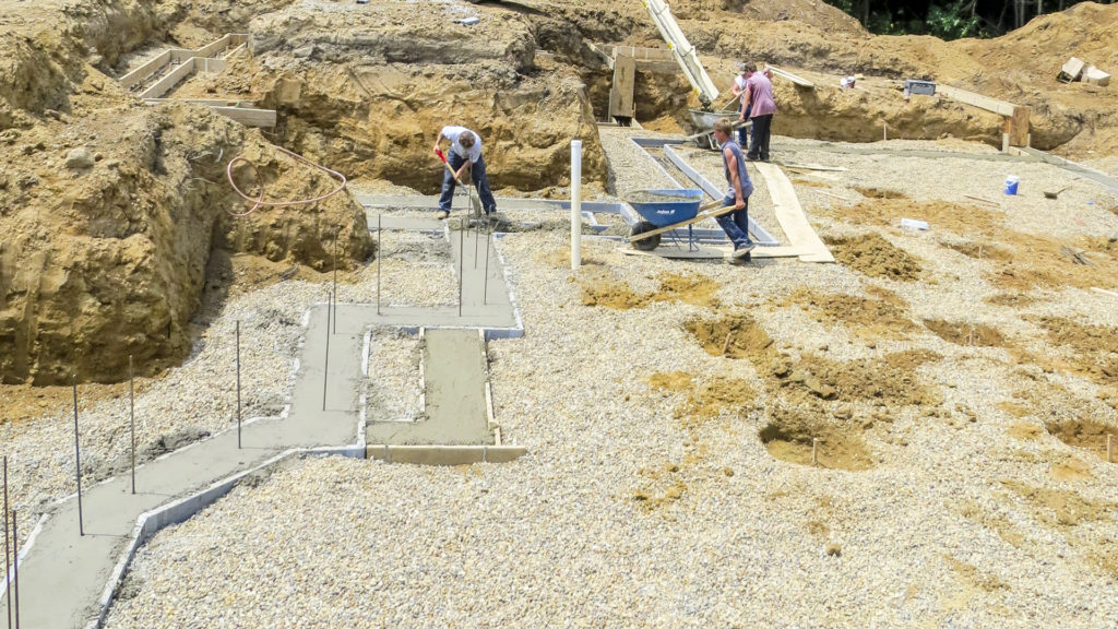 Footings with vertical rebar pins extending from the concrete